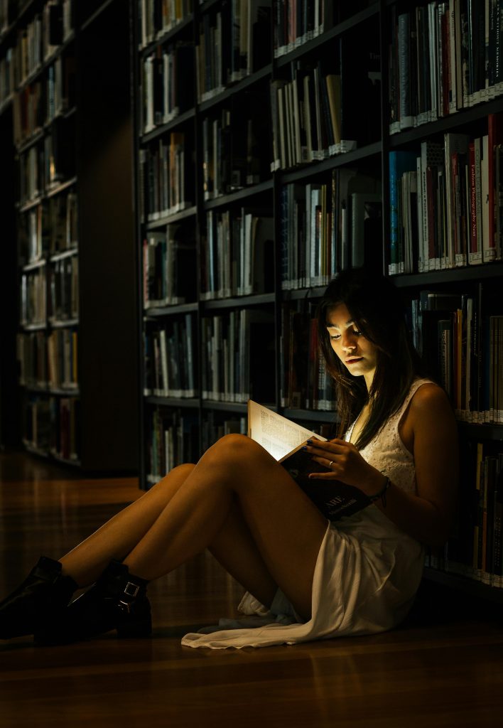 the right store design font choices will engage and captivate readers like this girl with a glowing book.